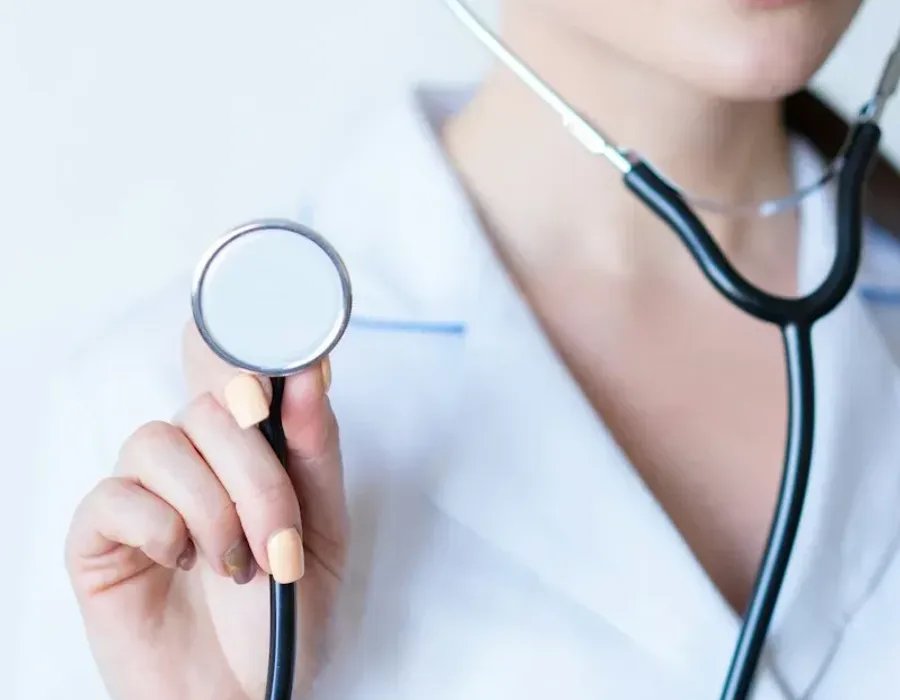 A woman doctor in a white coat with a stethoscope